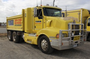 Side shot of Yugo Kenworth Medium Sized Yellow Truck | Yugo's Driving School
